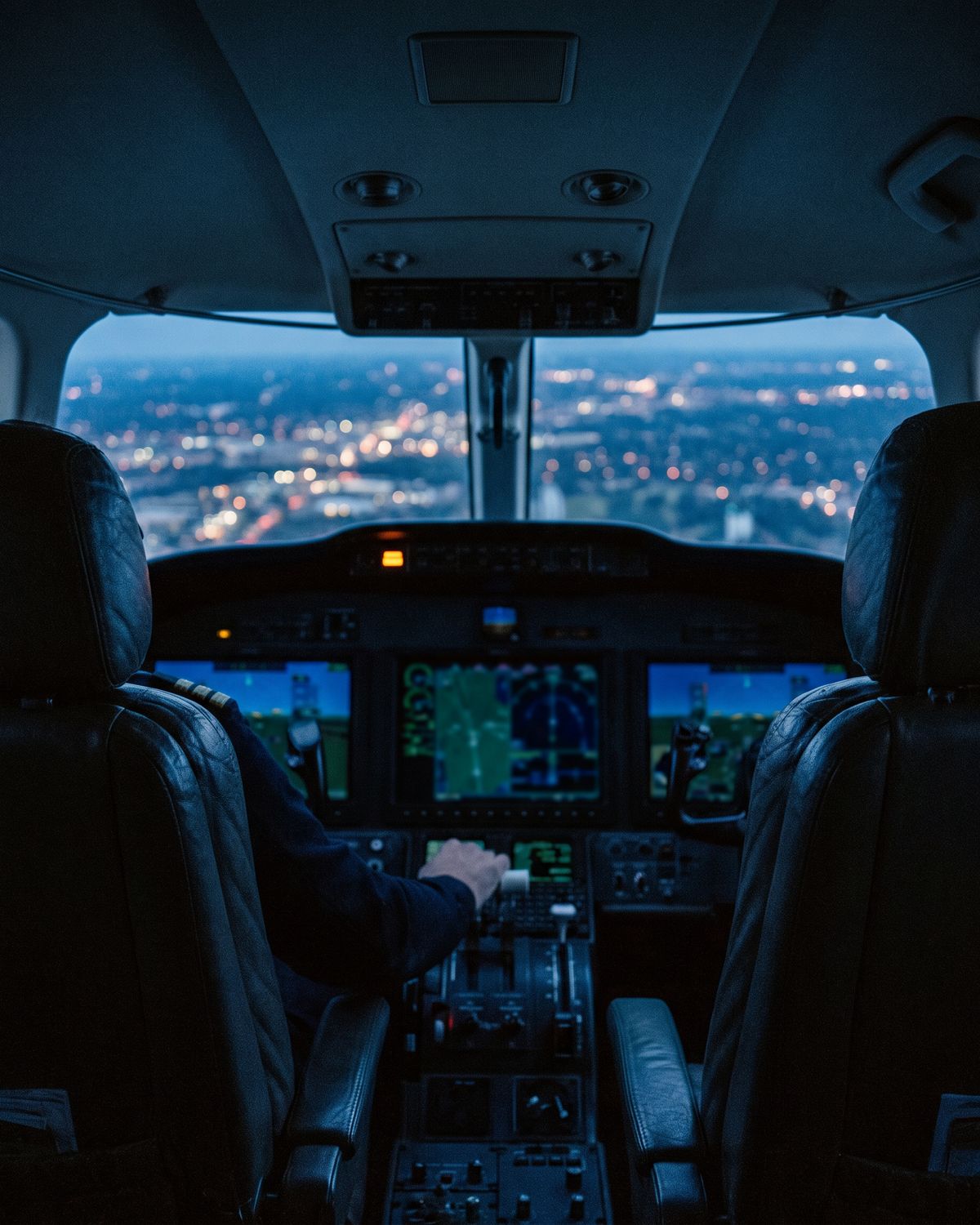 A flight deck at night with its displays lit